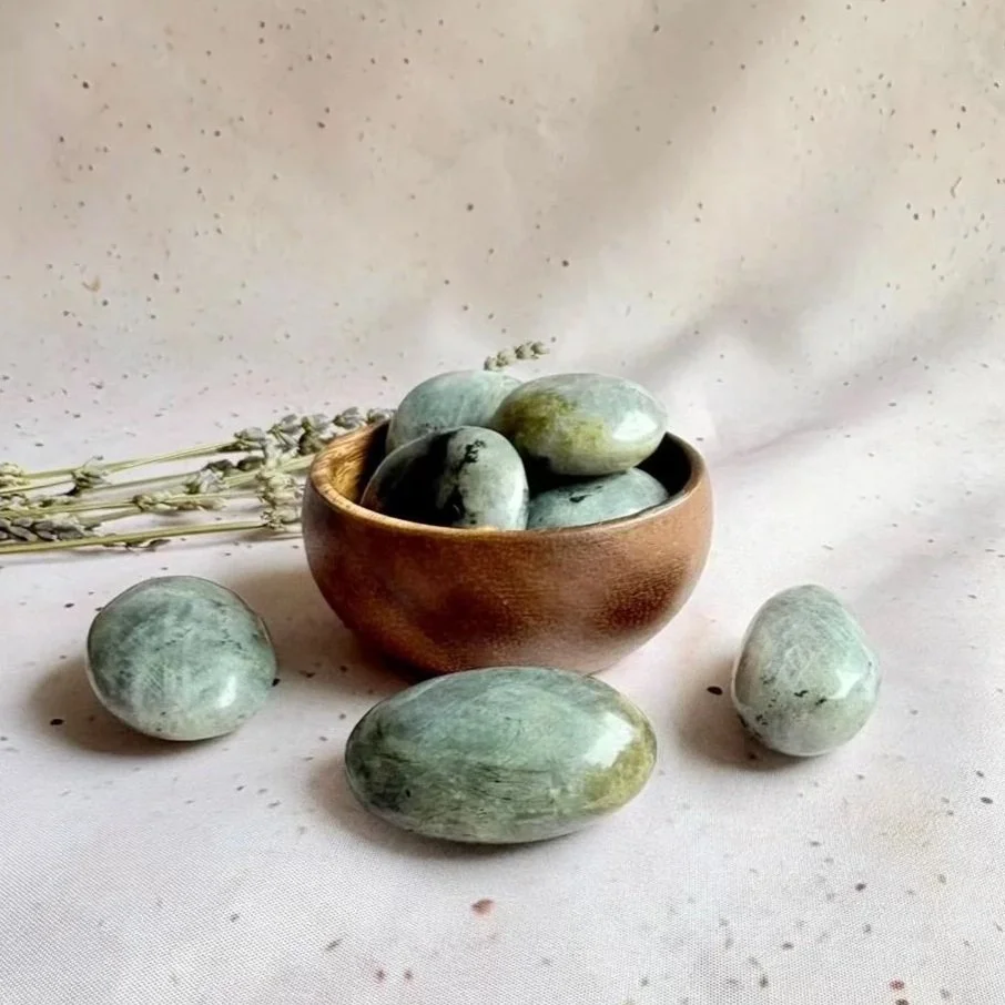 Labradorite palm stone associated with intuition, transformation, and protection