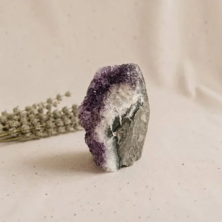 Amethyst cluster display piece featuring natural purple crystal formations and druzy sparkle