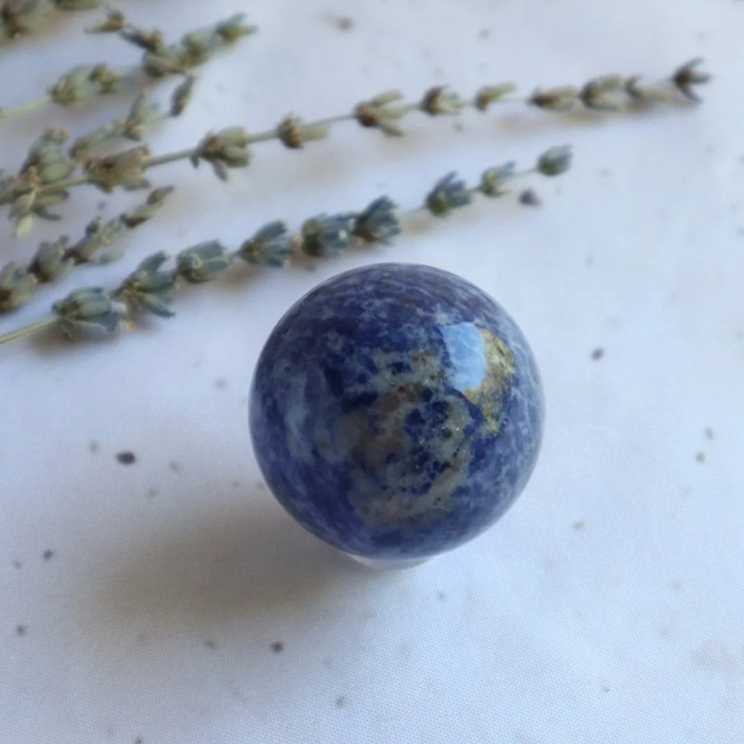Blue Sodalite sphere with natural colour variations and markings