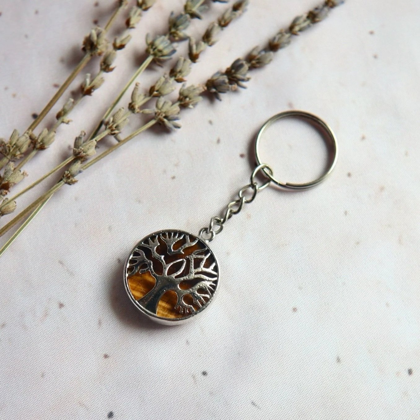 Tiger's Eye gemstone keyring featuring a golden-brown gemstone coin in a silver-tone Tree of Life frame.