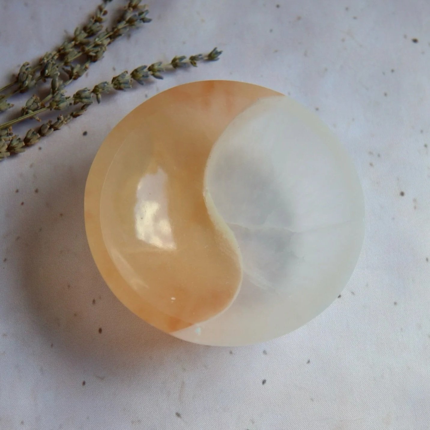 Two-tone Satin Spar round bowl featuring contrasting peach and white sections