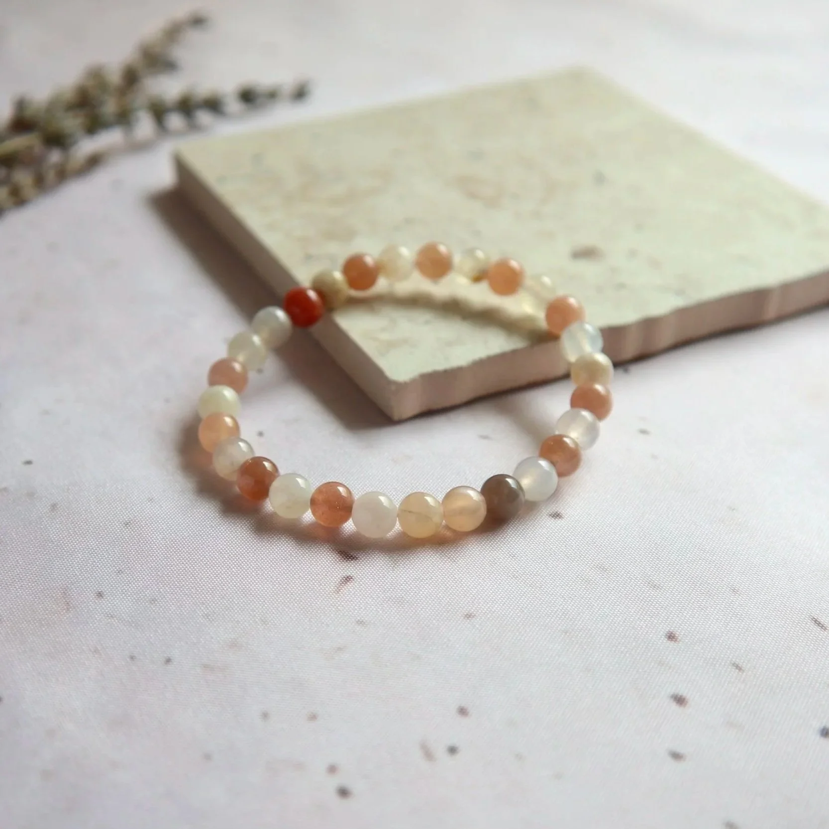 Mixed Moonstone round bead bracelet showing natural variations in colour and translucency.