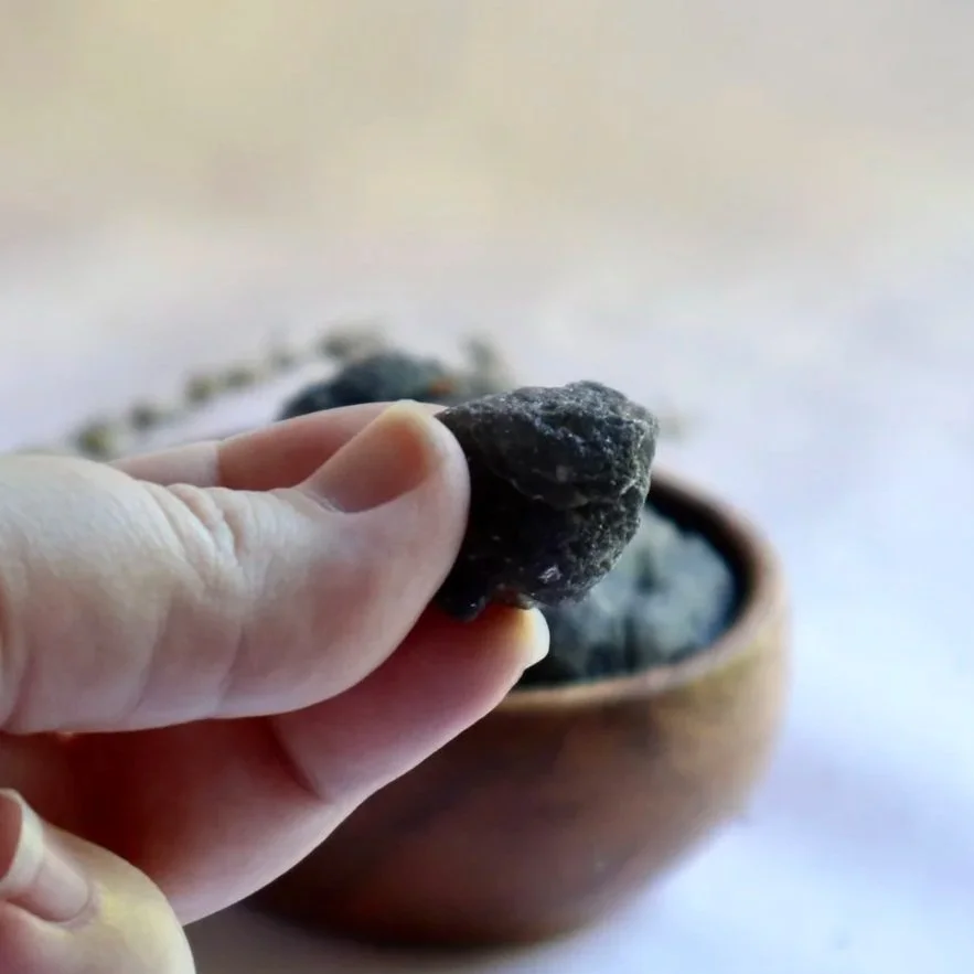 Rough Agni Manitite crystal held in hand showing natural texture and size