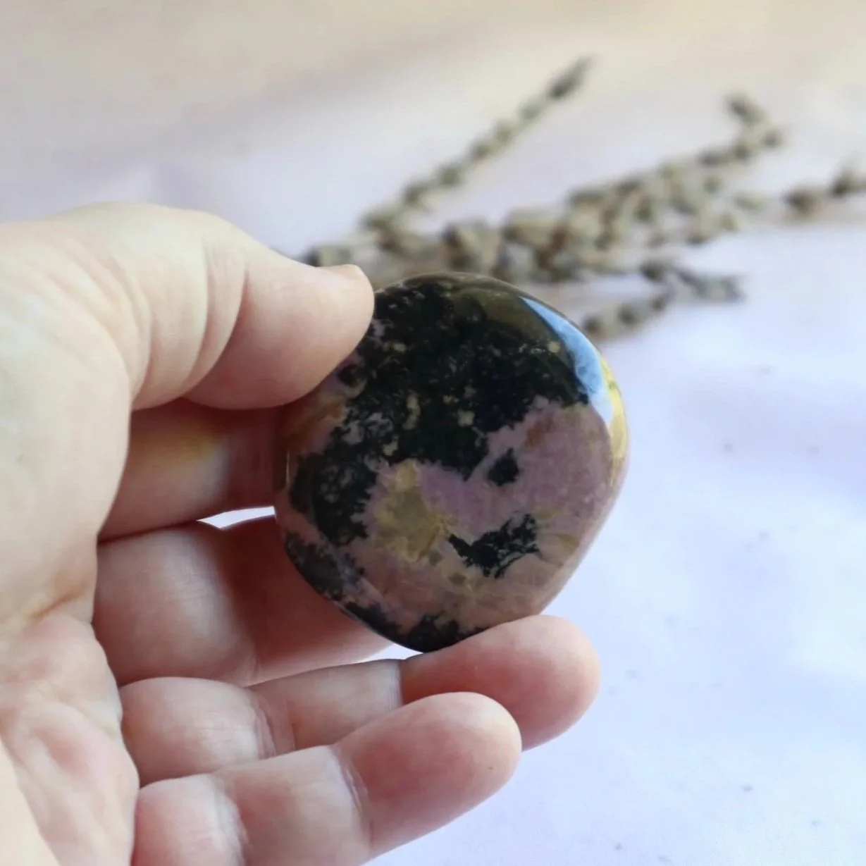 Polished Rhodonite flat stone with natural colour variations and markings