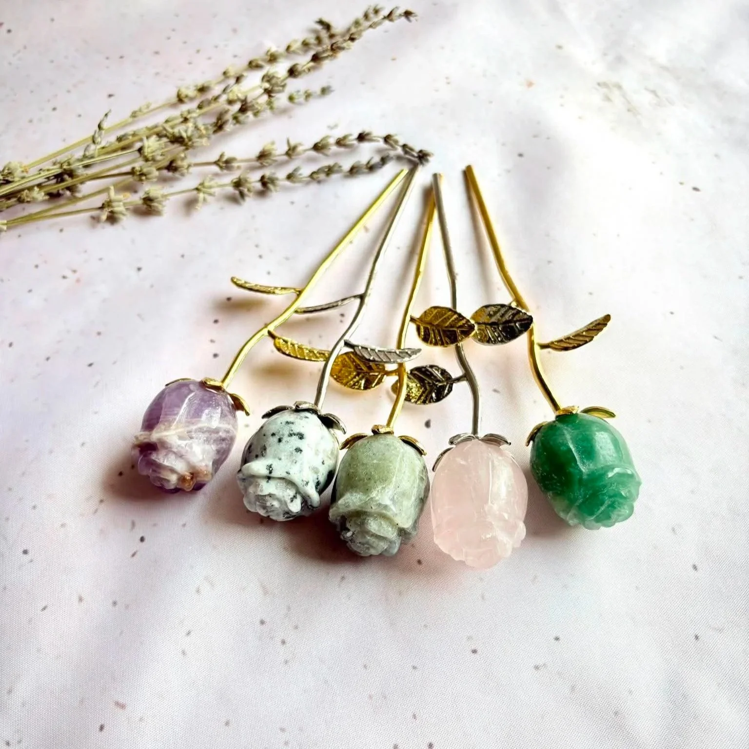 Selection of crystal roses in different natural crystal varieties with gold and silver stems