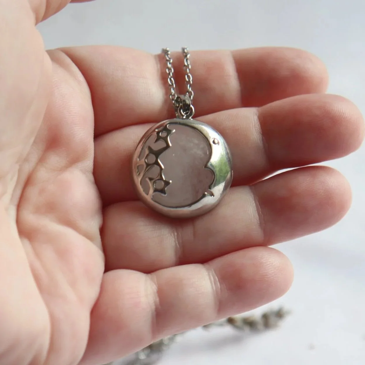 Natural Clear Quartz pendant in silver-toned moon and stars frame
