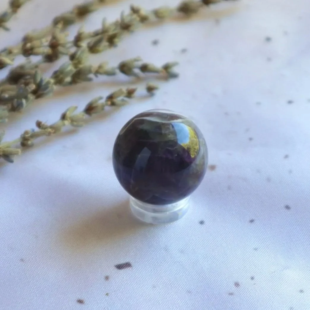 Polished purple and white Chevron Amethyst crystal sphere