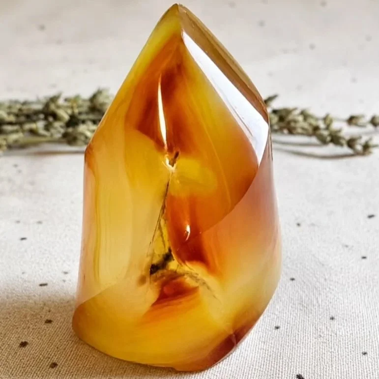 Carnelian flame carving featuring warm fiery tones and a polished finish for display