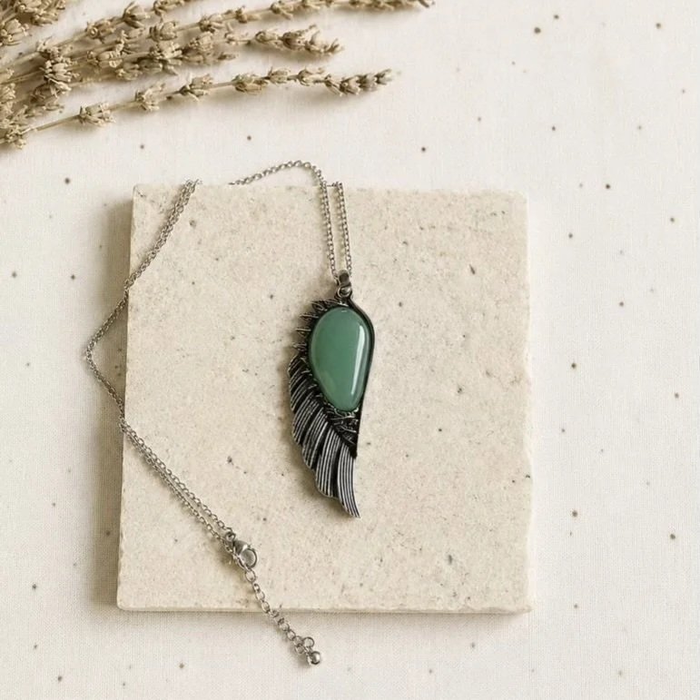 Natural Green Aventurine pendant set in an antique silver-toned wing design