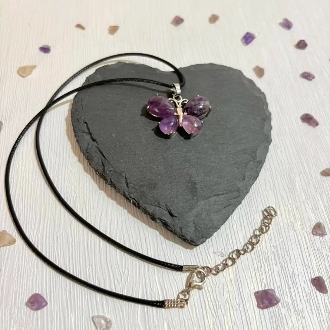 Crystal butterfly pendant necklace displayed on neutral background