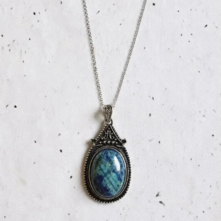 Natural Lapis Lazuli necklace featuring an oval gemstone pendant and stainless steel chain