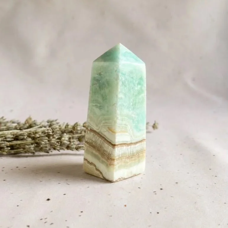 Natural Caribbean Calcite crystal tower featuring soft blue and sandy brown colouring.