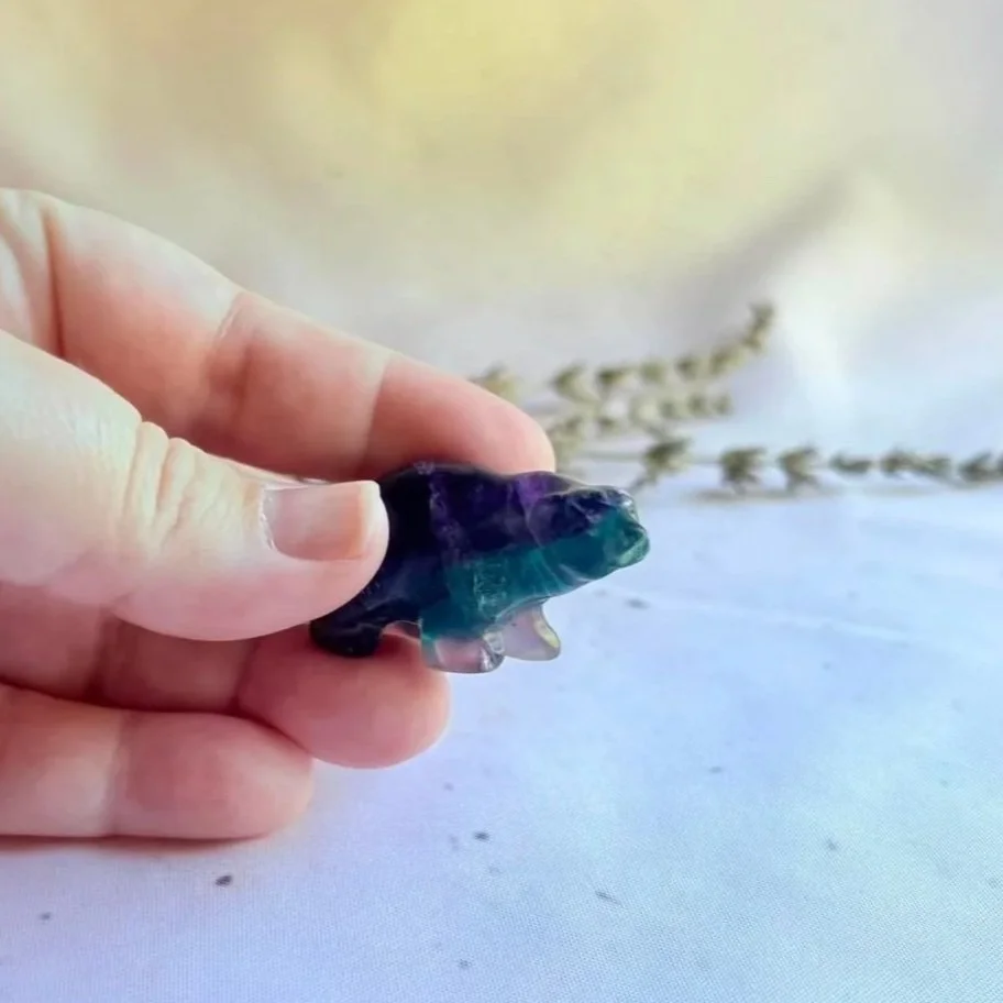 Fluorite crystal polar bear featuring natural green and purple banding