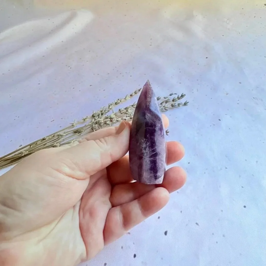 Dream Amethyst crystal tower featuring polished six-sided design