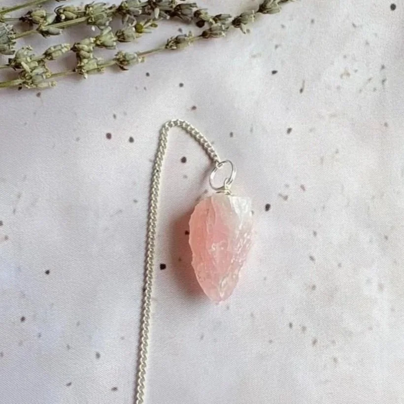Rough Rose Quartz pendulum featuring a natural unpolished crystal point