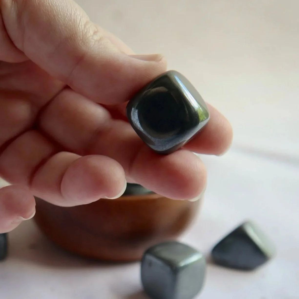 Shiny Hematite tumble displaying a smooth metallic finish and naturally chunky shape