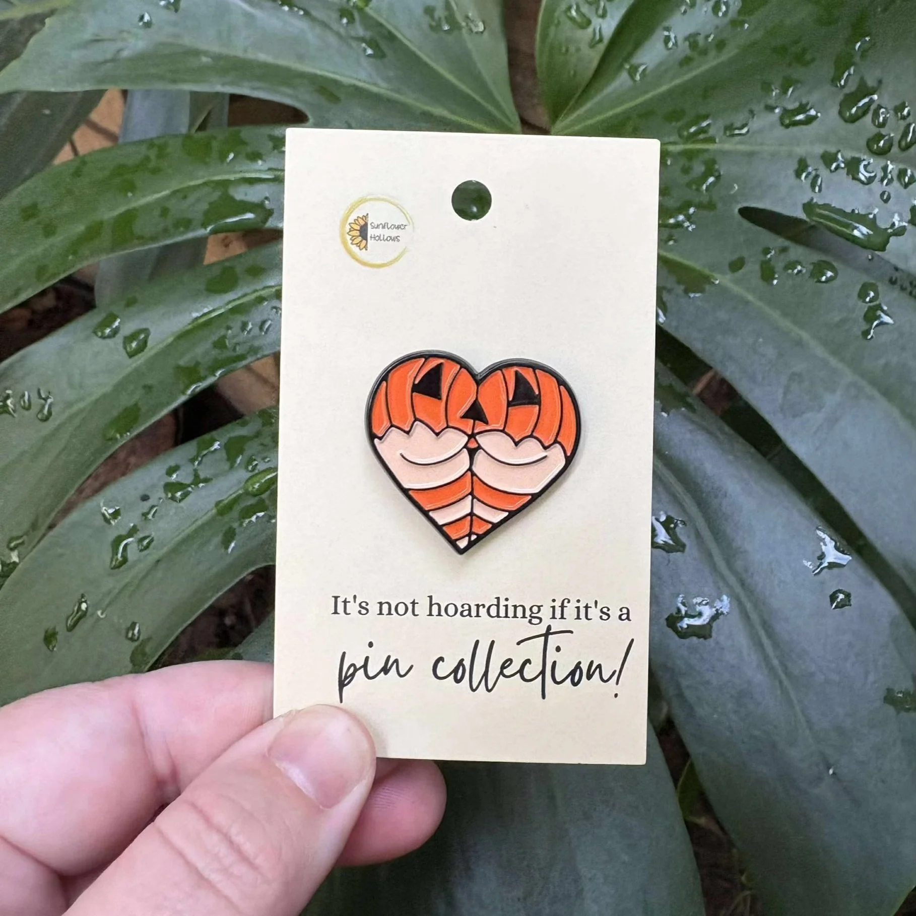 Love heart enamel pin featuring a cheeky butt wearing pumpkin-themed lingerie, quirky and festive Halloween accessory