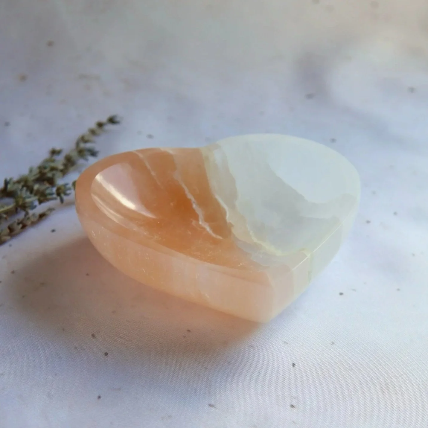 Natural Satin Spar heart bowl with soft peach and white colouring and silky fibrous texture