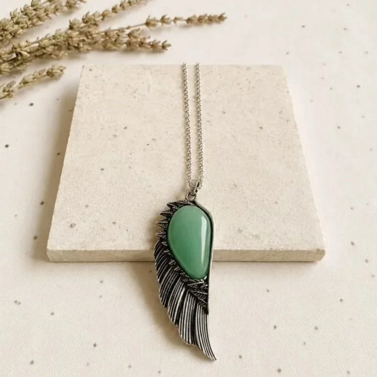 Green Aventurine crystal necklace displaying soft green colouring and wing-shaped mount