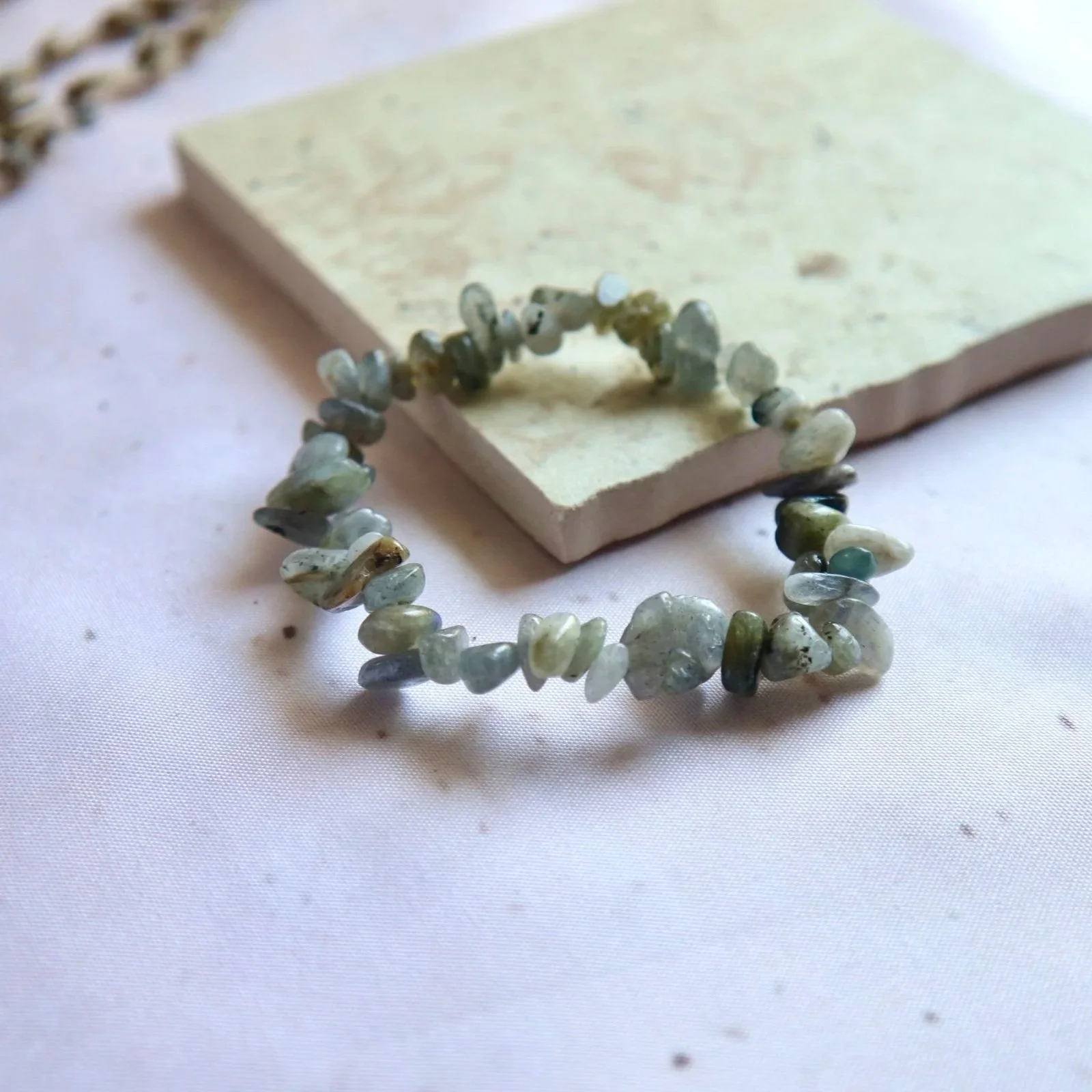 Polished Labradorite chip beads displaying natural variations in colour and shimmer.