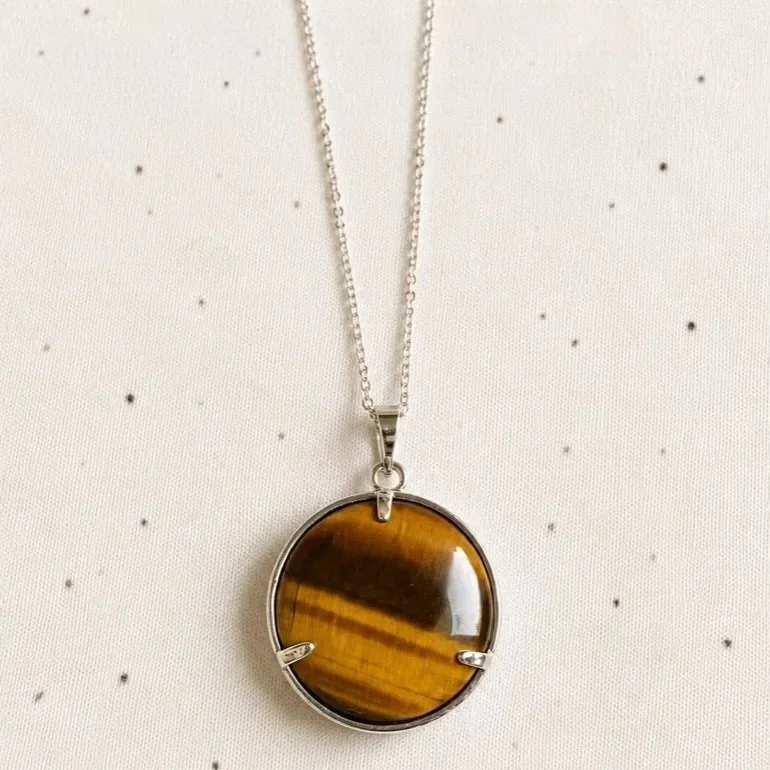 Natural Tiger's Eye pendant encased in a silver-toned Tree of Life frame