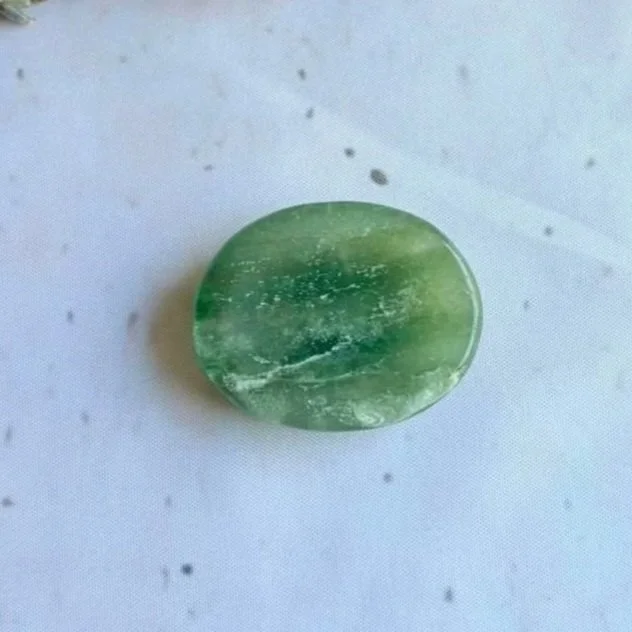 Natural New Jade oval worry stone with polished finish and thumb indentation