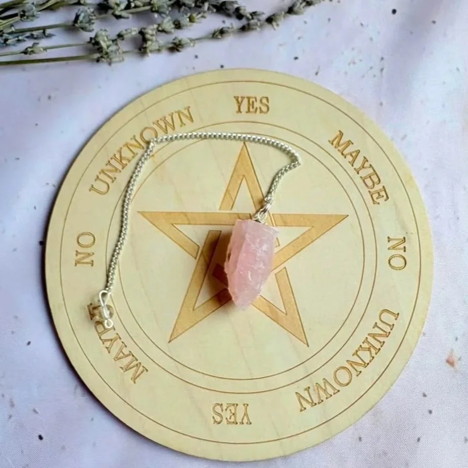 Natural Rose Quartz pendulum displaying soft pink colouring and raw texture