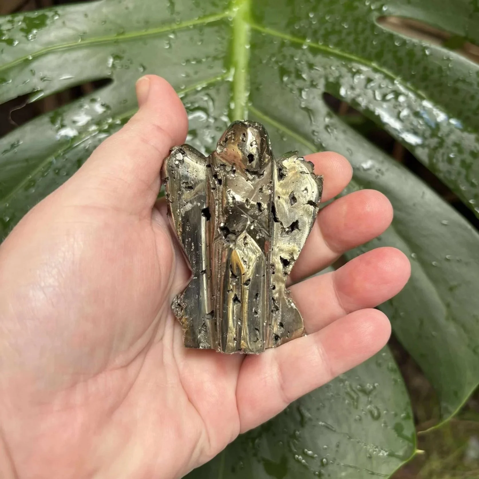 Golden Pyrite carved into an angel, sparkling with natural metallic shimmer—symbol of strength and prosperity.