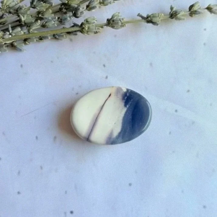 Natural Mookaite oval worry stone with polished finish and thumb indentation