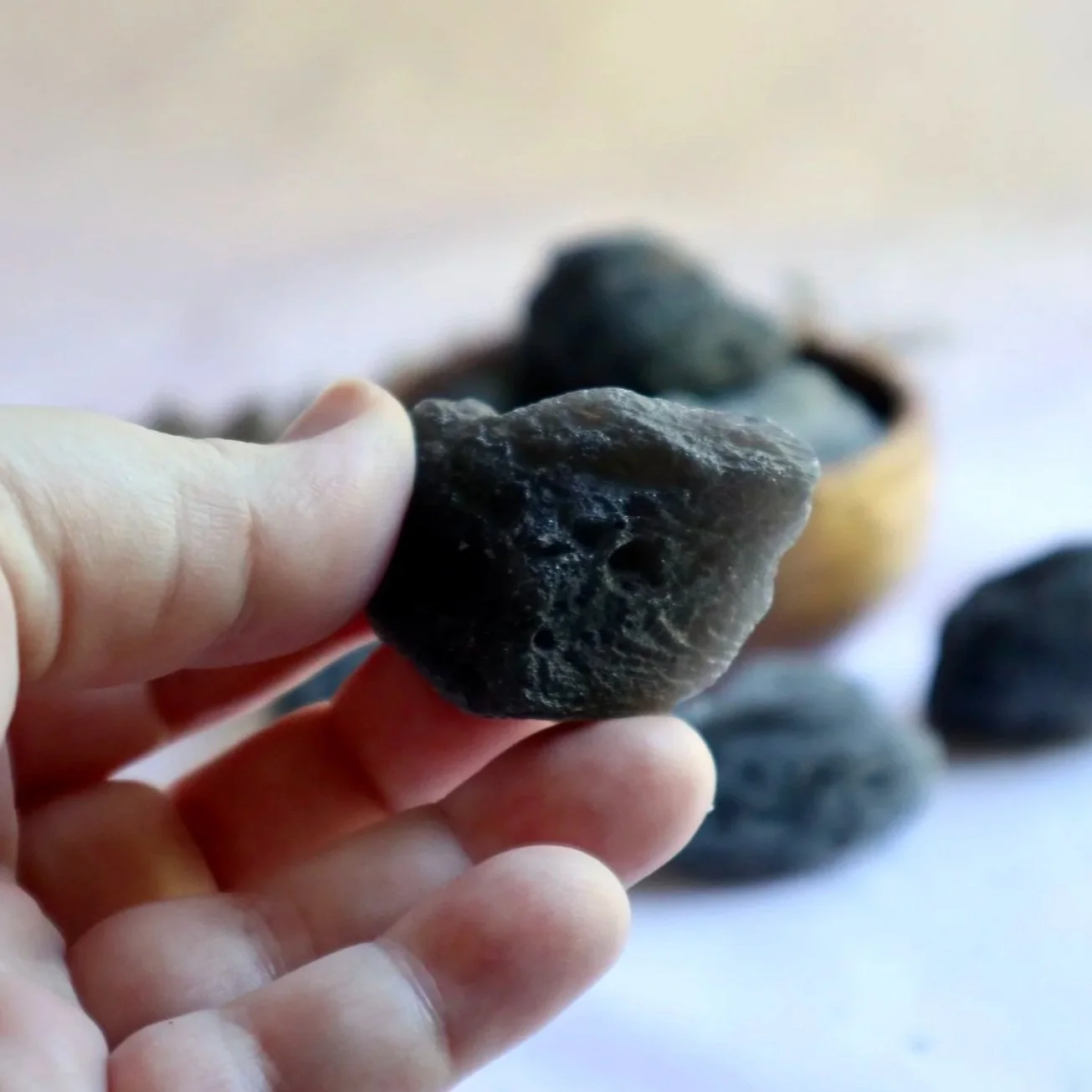 Rough Agni Manitite crystal held in hand showing natural texture and size