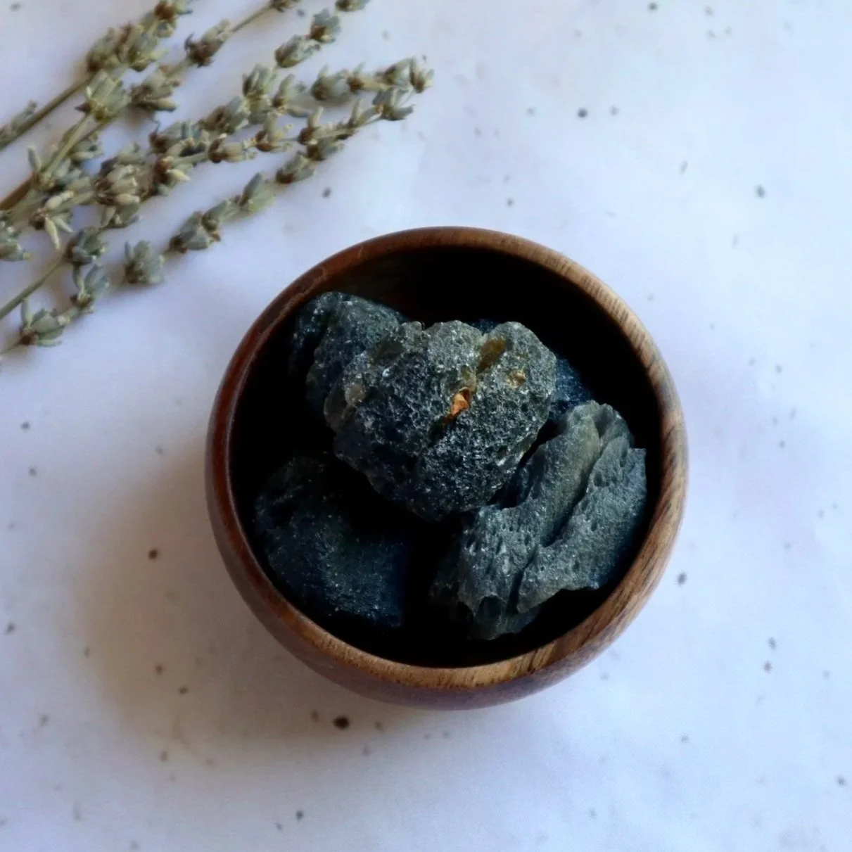 Natural rough Agni Manitite volcanic glass crystals in wooden bowl