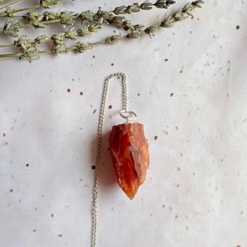 Carnelian rough pendulum featuring a natural unpolished crystal point