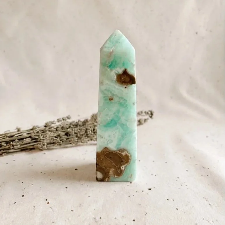 Natural Caribbean Calcite tower with calming blue and cream tones, polished into a six-sided point for display