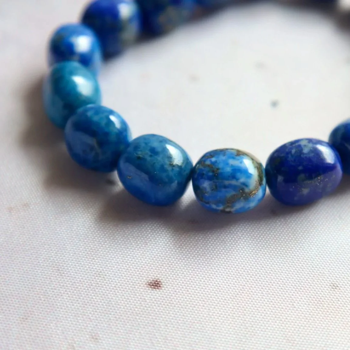 Natural Lapis Lazuli crystal bracelet with rounded tumble beads and unique blue and gold mineral variations