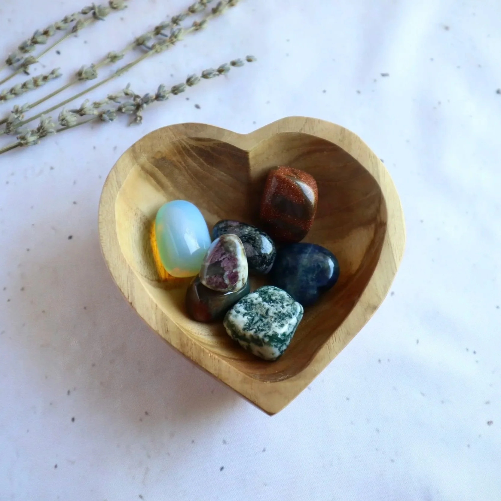 Decorative wooden heart bowl with natural timber grain for crystal and jewellery storage.