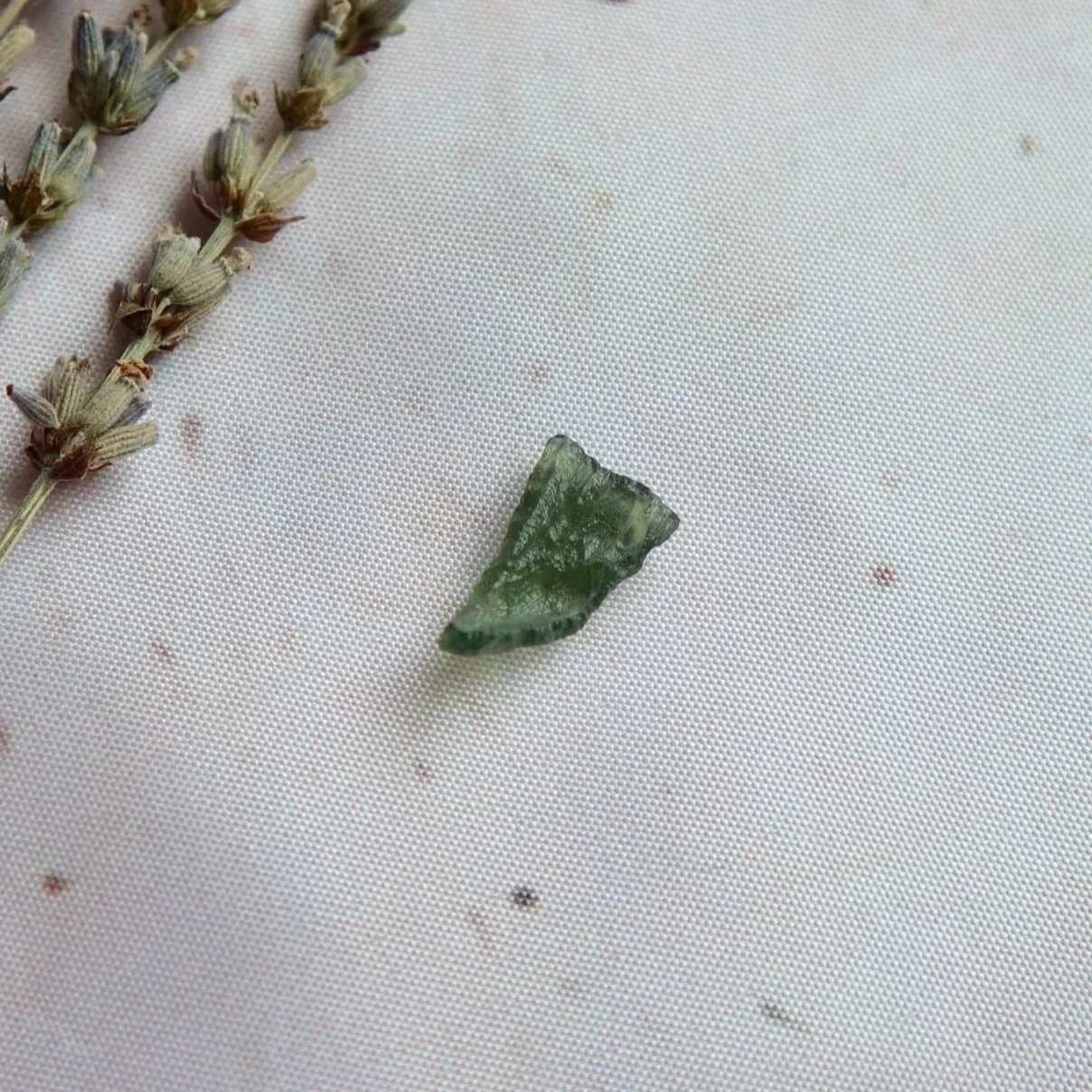 Moldavite specimen measuring approximately 1.5 × 0.8 cm