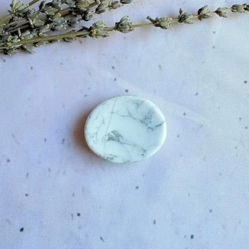 Natural Howlite oval worry stone with polished finish and thumb indentation