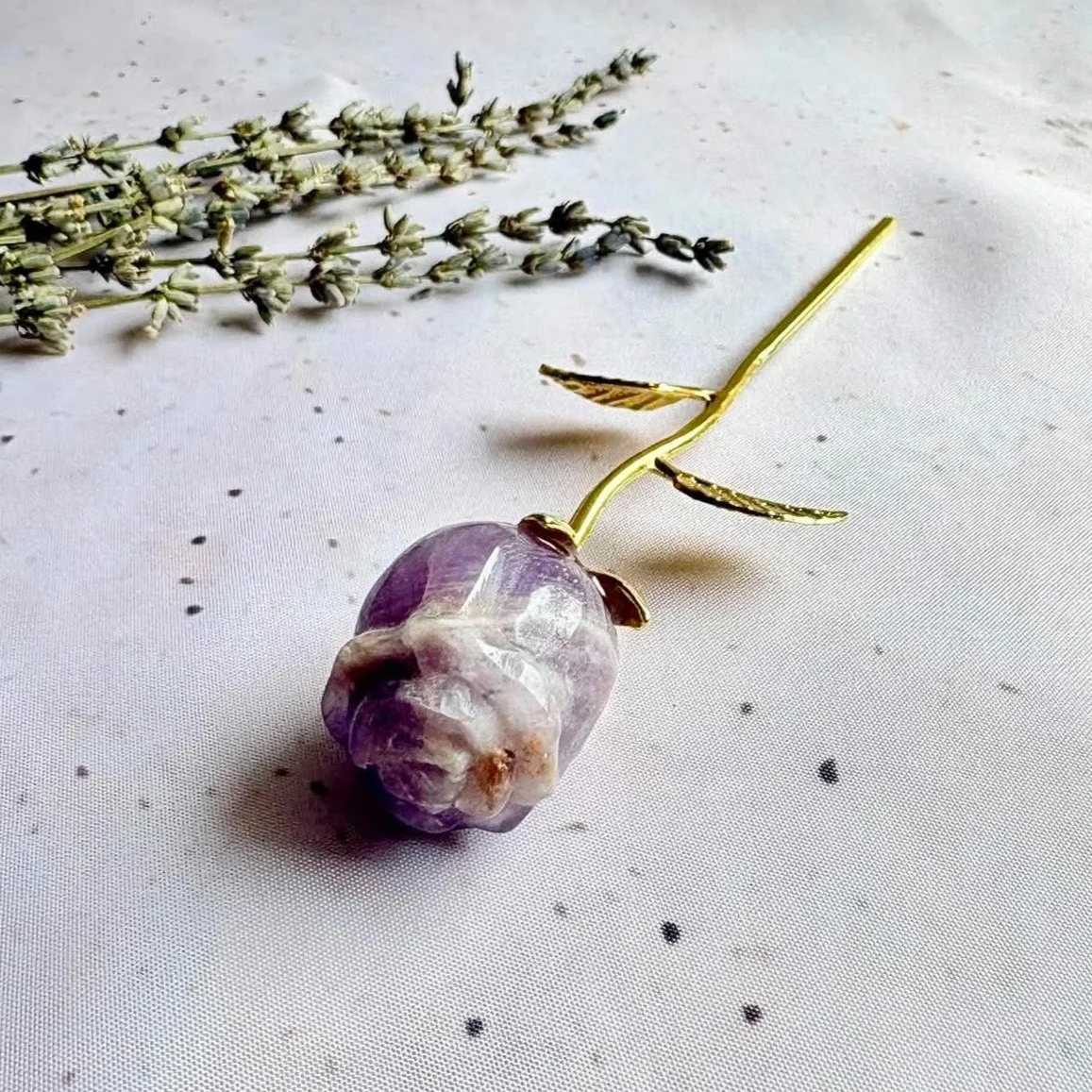 Amethyst crystal rose with a gold stem and decorative leaf detail