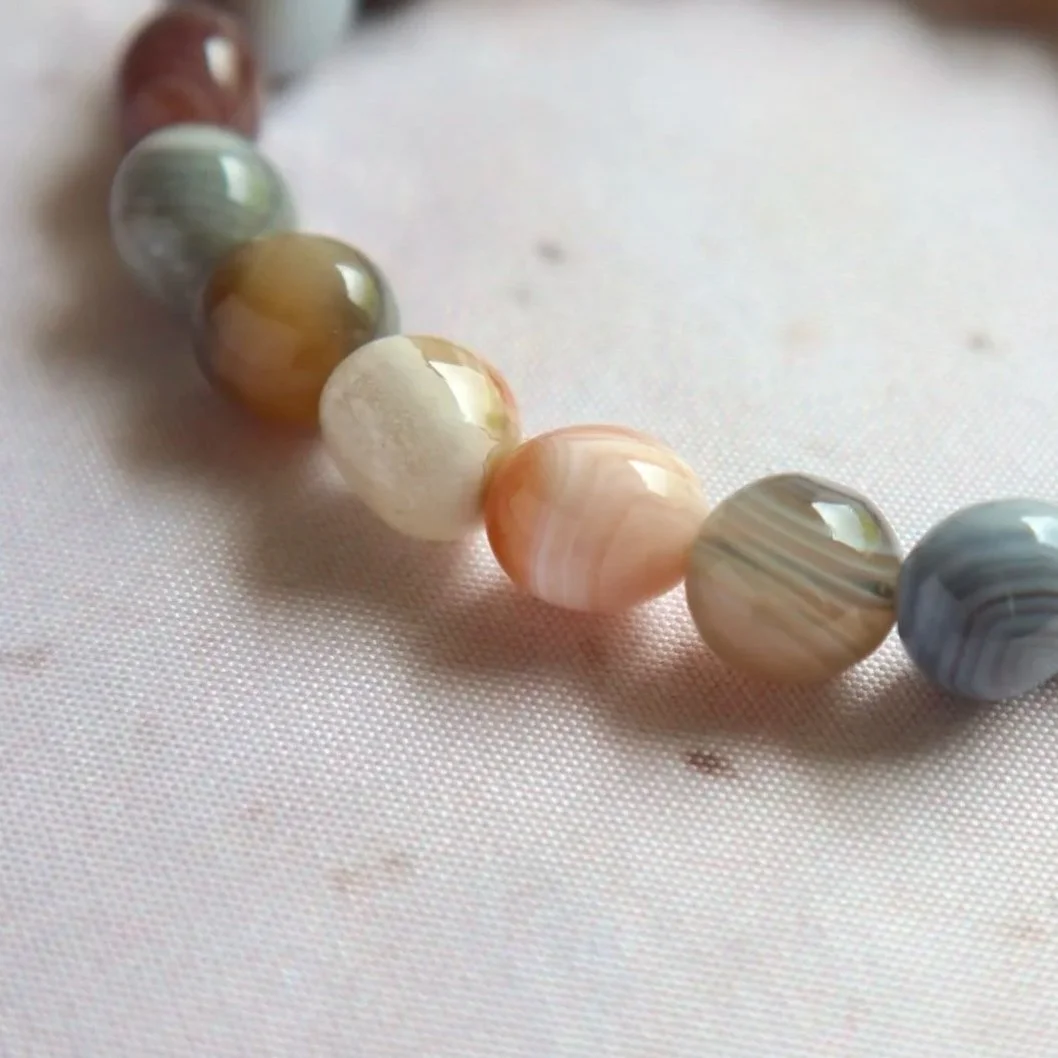 Polished Botswana Agate tumble bead bracelet featuring natural brown, grey and pinkish tones