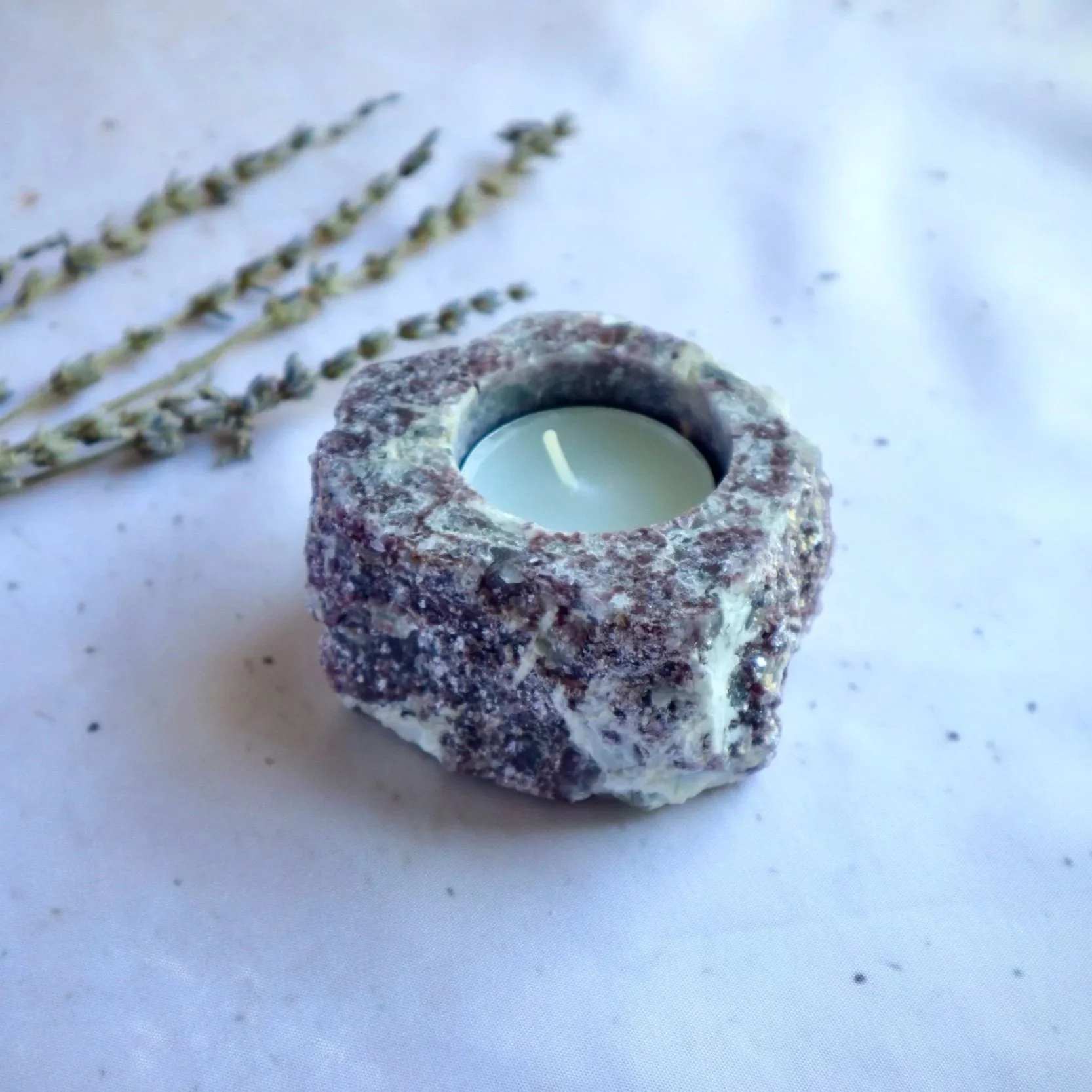 Natural Lepidolite tealight holder displayed with a tealight candle for scale