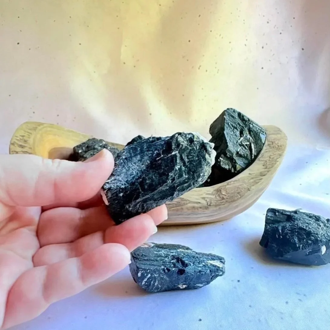 Raw Black Tourmaline crystal displaying natural striated texture and deep black colouring
