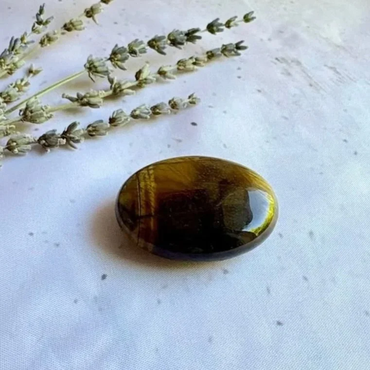 Polished Tiger's Eye crystal palm stone displaying natural silky shimmer