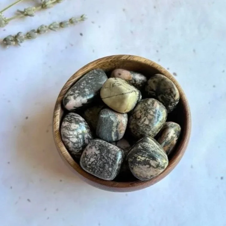 Rhodonite tumble associated with compassion, emotional healing, forgiveness, and self-love