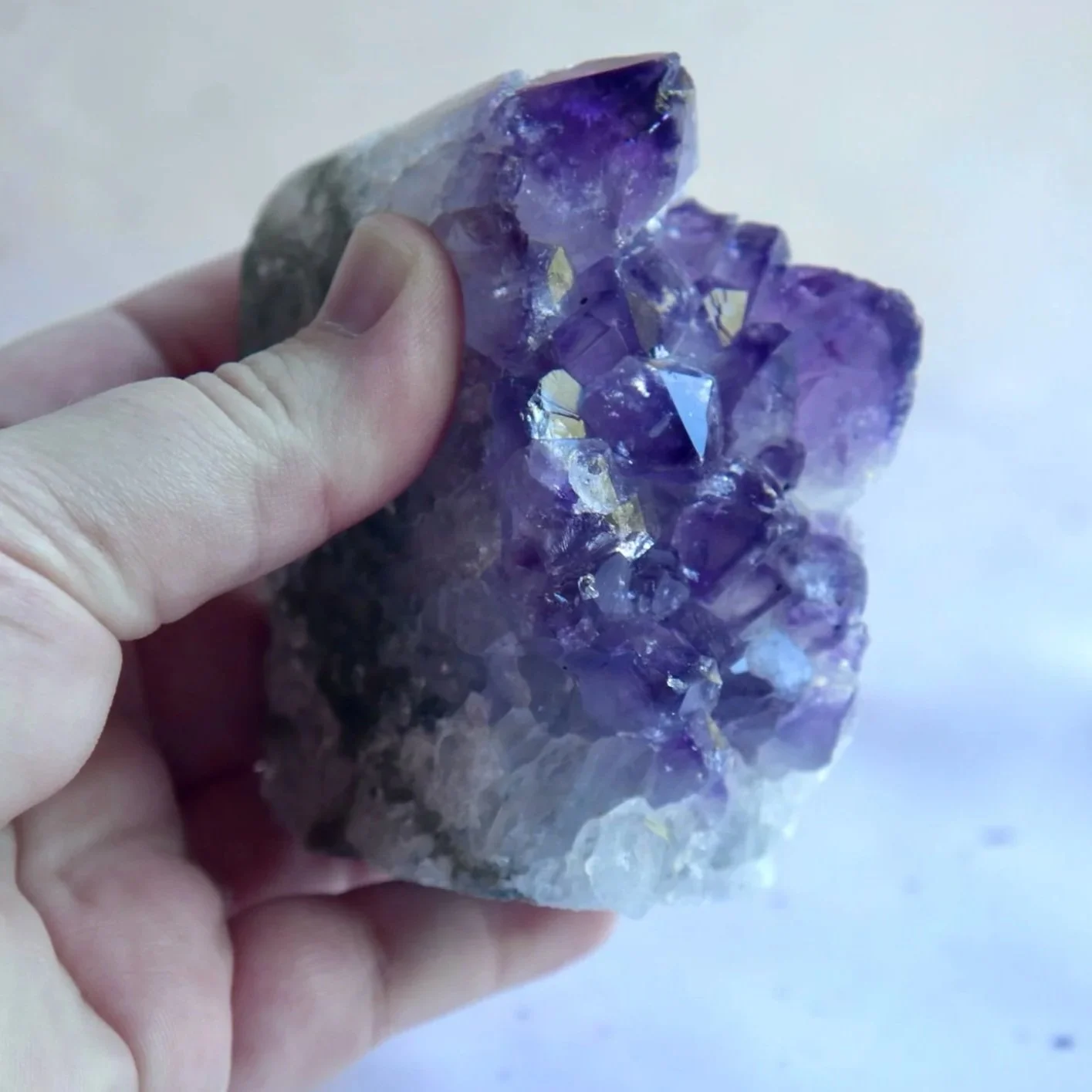 Natural Amethyst Cluster showing sparkling purple crystal points and unique formation