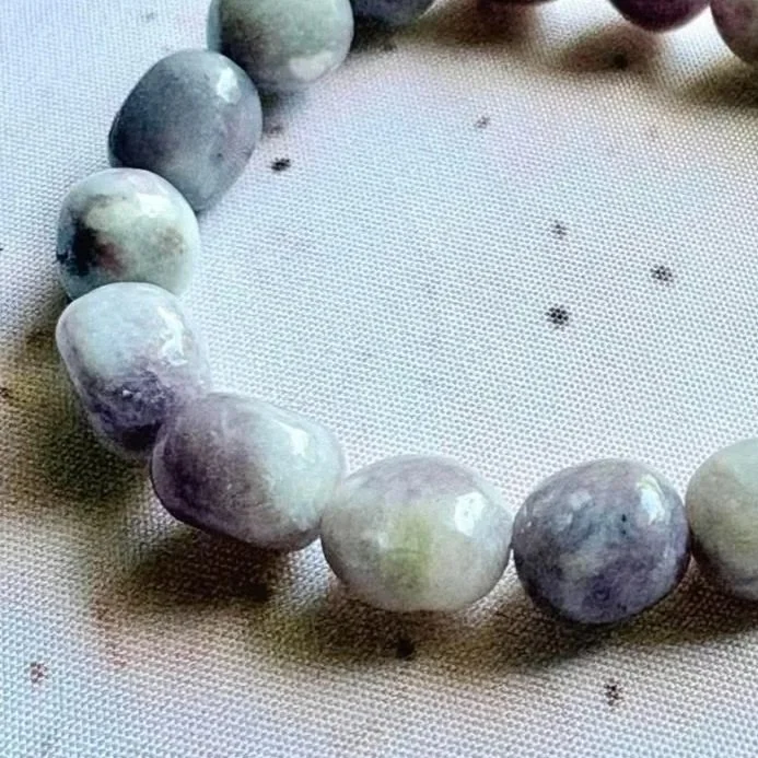 Stretch crystal bracelet with Pink Tourmaline inclusions suspended within Clear Quartz