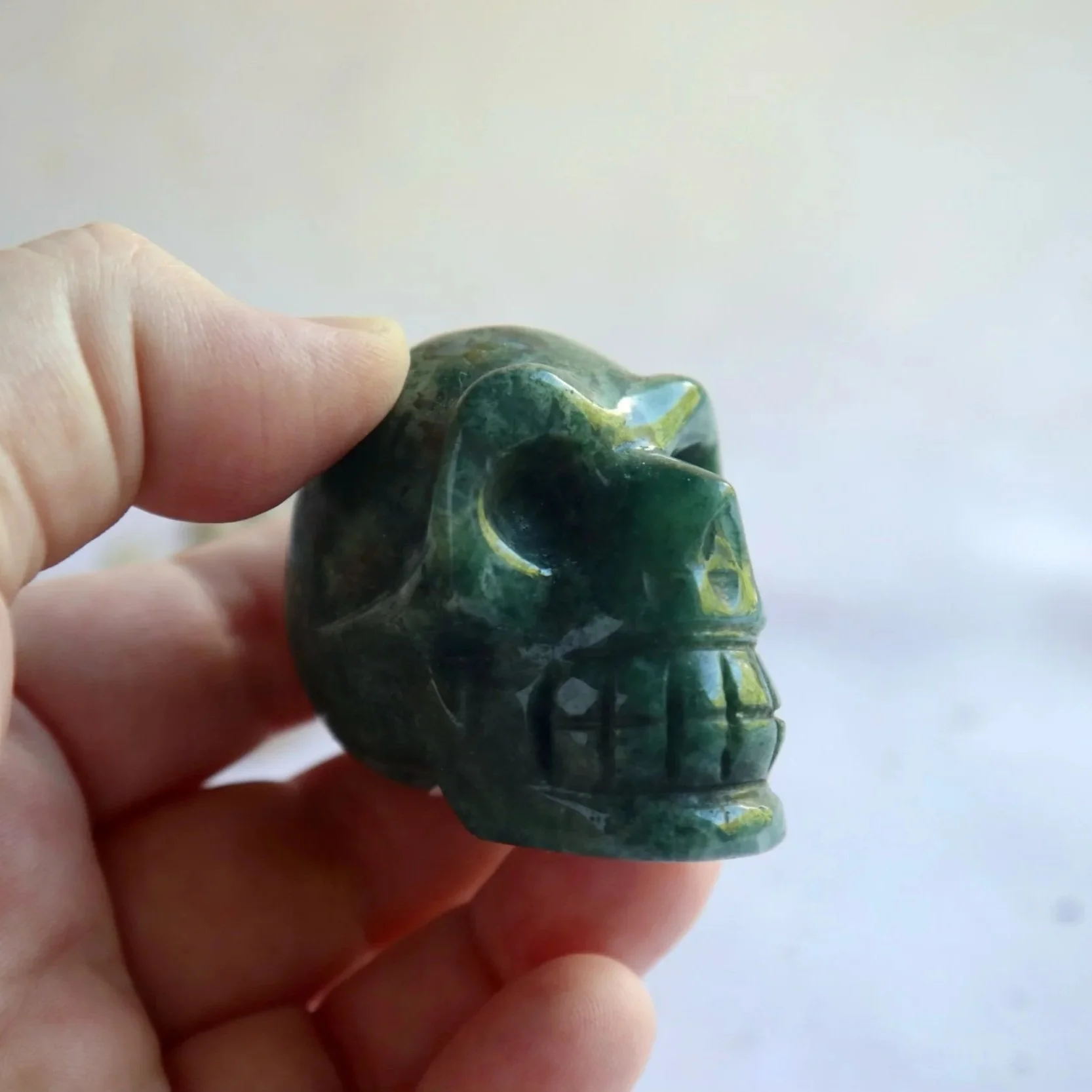 Polished Green Moss Agate crystal skull approximately 5cm wide