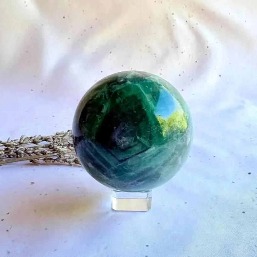 Natural Rainbow Fluorite sphere measuring approximately 7.3cm in diameter