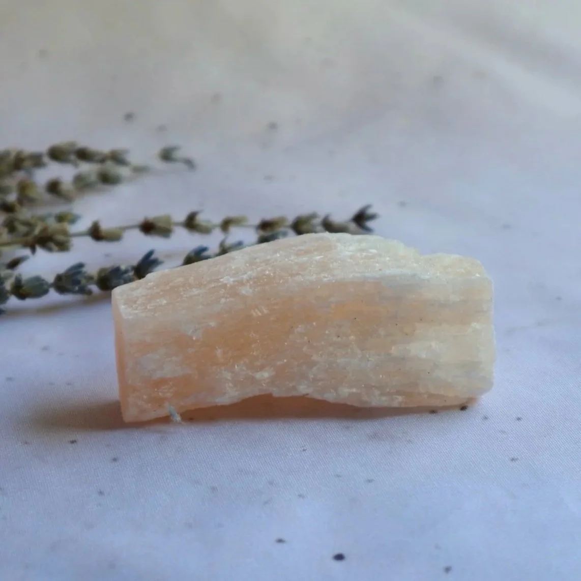 Natural Satin Spar crystal stick selected for its fibrous texture and soft white appearance