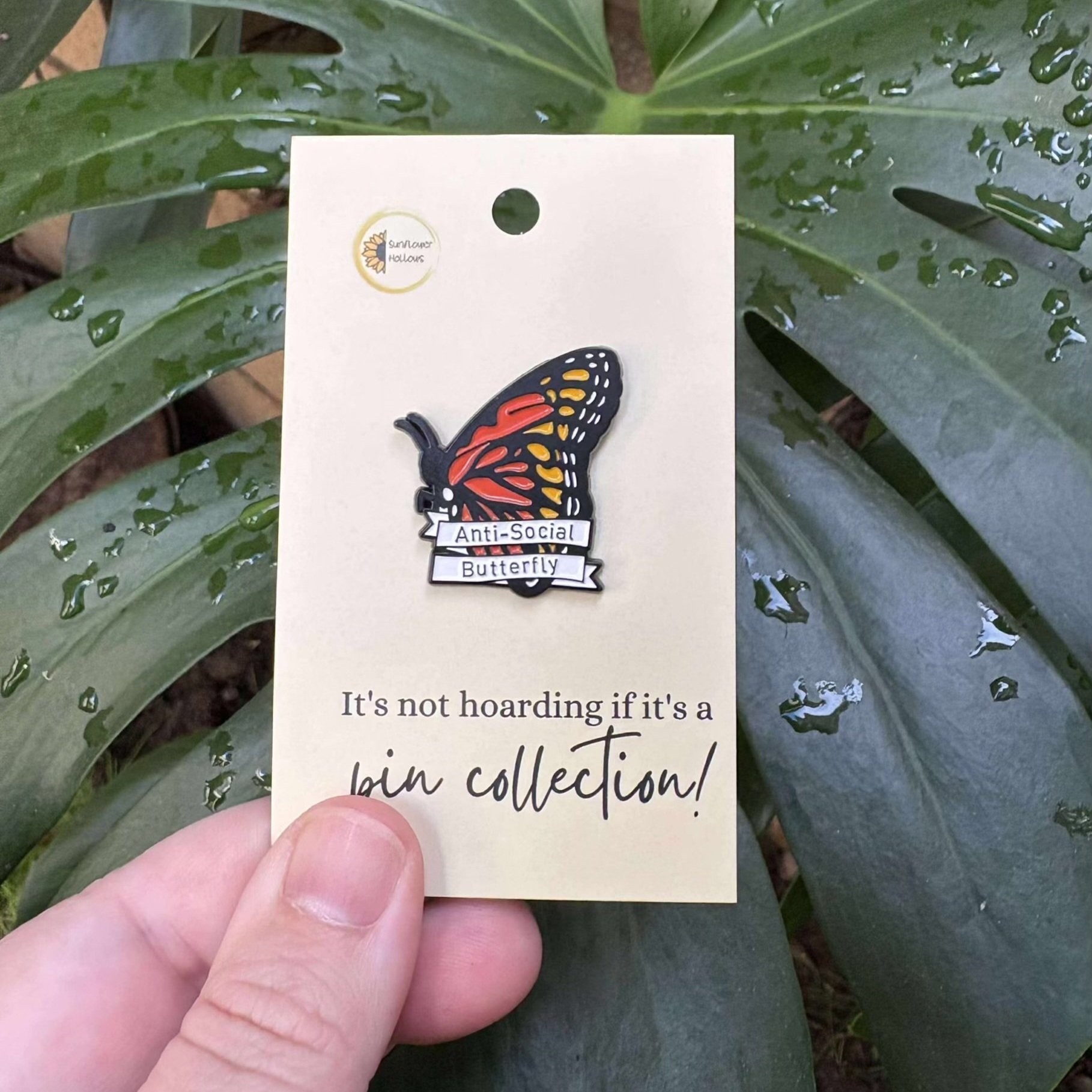 High-quality enamel pin shaped like a butterfly with playful “Antisocial Butterfly” lettering