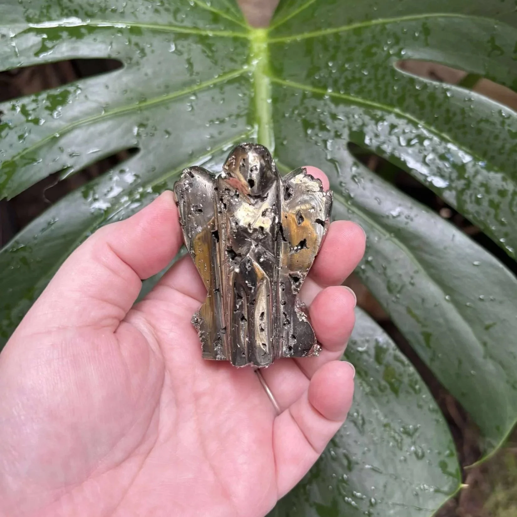 Shimmering Pyrite Angel crystal approximately 6.5cm tall, showcasing golden metallic hues and angelic shape, symbolizing protection and abundance.
